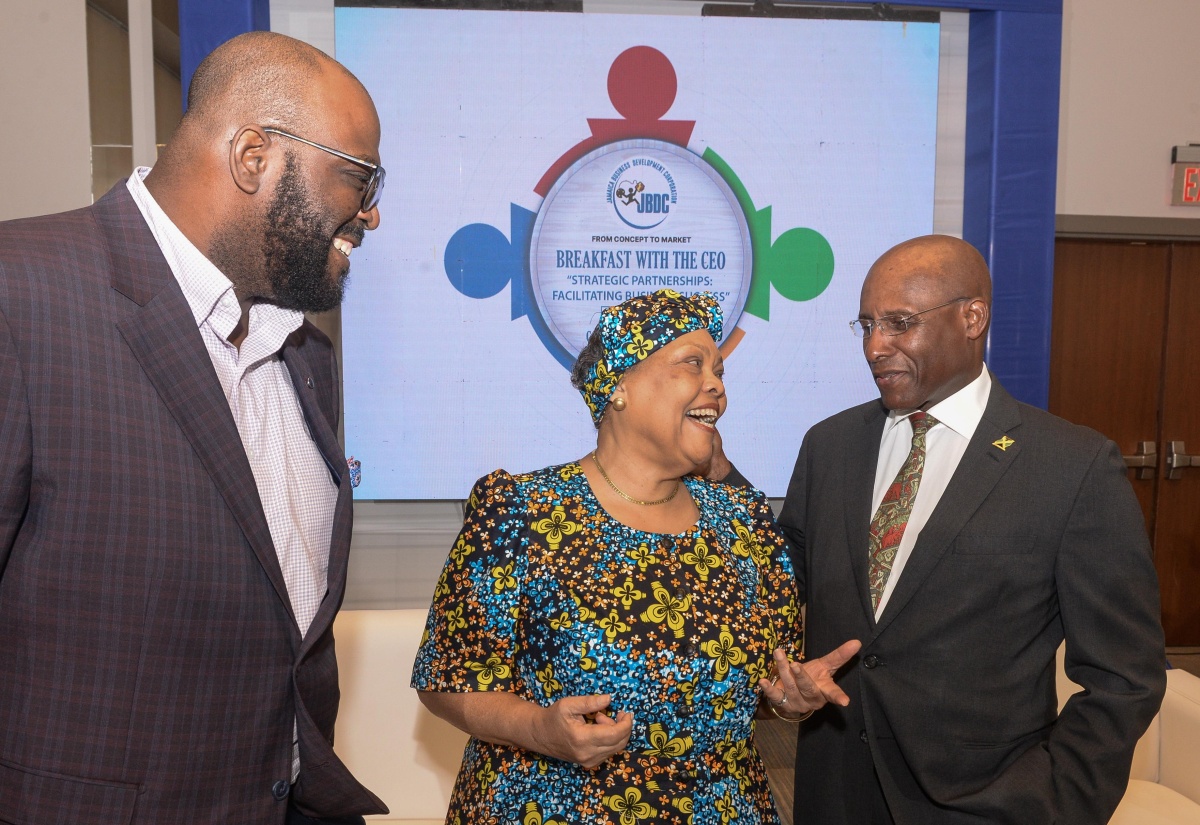 Minister of Industry, Investment and Commerce, Senator the Hon. Aubyn Hill (right), shares a light moment with the Jamaica Business Development Corporation’s Chief Executive Officer, Valerie Veira (centre) and Deputy Chief Executive Officer, Harold Davis, during the agency’s ‘Breakfast with the CEO’ event held recently at the AC Marriott Hotel in New Kingston.