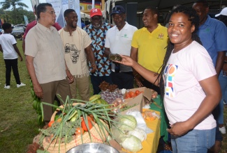 Minister of Agriculture, Fisheries and Mining, Hon. Floyd Green (fifth left), interacts with (from left): Minister of State in the Office of the Prime Minister (West), Hon. Homer Davis; Mayor of Montego Bay and Chairman of the St. James Municipal Corporation, Councillor Richard Vernon; Custos Rotulorum for St. James, Bishop the Hon. Conrad Pitkin; President of the St. James Branch of the Jamaica Agricultural Society (JAS), Glendon Harris; and Parish Manager for the St. James Division of the Rural Agricultural Development Authority (RADA), Ricardo Holt, as they tour the grounds of the 41st staging of the Montpelier Agricultural & Industrial Show, held at the Montpelier Show Ground on Easter Monday (April 1).  At right is farmer, Susan Clarke. 