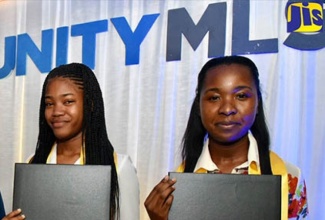 Recipients of the Programme of Advancement Through Health and Education (PATH) 15th anniversary tertiary scholarships Brittney Munroe (left) and Shanique Davidson. The presentation was made at the Ministry of Labour and Social Security in Kingston in 2018. 