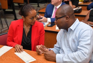 Minister of Legal and Constitutional Affairs, Hon. Marlene Malahoo Forte (left), converses with University of the West Indies (UWI) Pro-Vice Chancellor and UWI Mona Principal, Professor Densil Williams. The occasion was the Faculty of Law’s Distinguished Lecture and Reasoning about ‘Judicial Policy Construction by Apex Courts’ on Wednesday (April 24). 