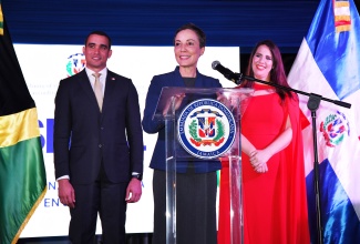Minister of Foreign Affairs and Foreign Trade, Senator the Hon. Kamina Johnson Smith, addresses the Dominican Week gala reception at the Dominican Republic Ambassador’s official residence in Kingston on Thursday (April 18). Listening are Ambassador of the Dominican Republic to Jamaica, Her Excellency, Angie Martinez, and the country’s Vice Minister of Bilateral Foreign Policy, José Julio Gómez.