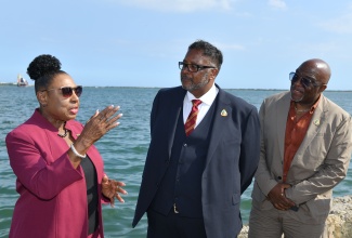 Minister of Culture, Gender, Entertainment and Sport, Hon. Olivia Grange (left), shares in conversation with Director and Advocate, Windrush Generations United Kingdom (UK) and Director of Windrush National Organization, Nigel Guy (centre) and Director and Advocate, Windrush Generations UK, Charles Dacres. Occasion was a visit to the site of the upcoming Windrush Storyboard at the Waterfront, downtown Kingston, on April 16. Ms. Grange received the new Windrush Standard during the visit.

