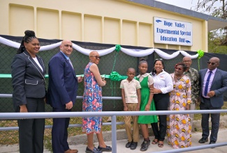 Minister of Education and Youth, Hon. Fayval Williams (third left), cuts the ribbon to officially hand over the Special Education Unit at the Hope Valley Experimental School in St. Andrew on Thursday (April 18). Joining her (from left) are Education Officer in the Ministry’s Special Education Unit, Christina Addington; Country Representative, United States Agency for International Development (USAID), Dr. Jaidev Singh; students Jehue Mullings and Ashley Holland; Chief Executive Officer of the Digicel Foundation, Charmaine Daniels; Parent-Teacher Association (PTA) President, Hope Valley Experimental, Georgette McGlashen-Miller; Board Chairman of the school, Noel Osbourne; and Principal, Anthony Grant.

