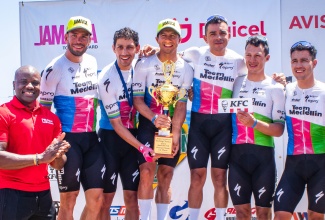 Head of Communications and Corporate Affairs at Digicel, Elon Parkinson (left), with the victorious Team Medellin of Colombia, at the end of the three-day Jamaica Cycling Classic in Montego Bay, on April 7.