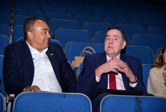 Minister of Health and Wellness, Dr. the Hon. Christopher Tufton (left), engages in light conversation with Director of the Pan American Health Organization (PAHO) and World Health Organization (WHO) Regional Director for the Americas, Dr. Jarbas Barbosa da Silva Jr. The occasion was the screening of a 30-minute documentary titled ‘Dying Young: Lifestyle Choices and the NCD Crisis’, highlighting the impact of non-communicable diseases (NCDs), at Courtleigh Auditorium in Kingston on Wednesday (May 8).