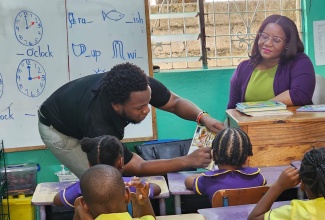 Chief Executive Officer, Cannabis Licensing Authority (CLA), Farrah Blake (right), hands over books to Principal, Little Angels Early Childhood Centre, Rose Spence, on May 20. The books were among items donated by the CLA.