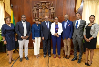 Minister of Tourism, Hon. Edmund Bartlett (fourth left), shares a photo opportunity with tourism stakeholders during Wednesday’s (May 1) post-Cabinet press briefing at Jamaica House. Pictured (from left) are Executive Director of Jamaica Vacations, Joy Roberts; Tourism Product Development Company (TPDCo) Executive Director, Wade Mars; Devon House Executive Director, Georgeia Robinson; Permanent Secretary in the Ministry, Jennifer Griffith; Director of Tourism, Donovan White; Executive Director of the Tourism Enhancement Fund (TEF), Dr. Carey Wallace; and Junior Consultant to the Minister, Paige Gordon. 

