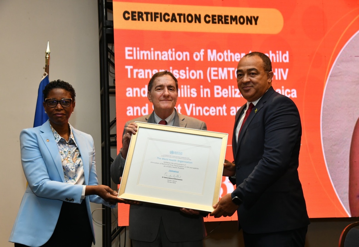 Health and Wellness Minister, Dr. the Hon. Christopher Tufton (right), is presented with a certificate for the Elimination of mother-to-child transmission (EMTCT) of HIV and Syphilis in Jamaica, by Pan American Health Organization (PAHO) Director, Dr Jabas Barbosa (centre), and Assistant Director, Dr Rhonda Sealy-Thomas. Belize, and St. Vincent and the Grenadines also received certification at the ceremony held on Tuesday (May 7) at The Jamaica Pegasus hotel in St. Andrew.

