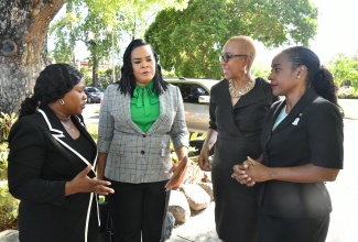 Minister of Education and Youth, Hon. Fayval Williams (second right), in discussion with (from left):Manager, Investigation Unit, Child Protection and Family Services Agency (CPFSA), Ericka Gilbert-Hope; Chief Executive Officer, CPFSA, Laurette Adams Thomas and Minister of State in the Ministry of Education and Youth, Hon. Marsha Smith, at the CPFSA ‘Ananda Alert Conference: Strengthening Responses to Missing Children’, at the Terra Nova All-Suite Hotel in St. Andrew, on May 24.