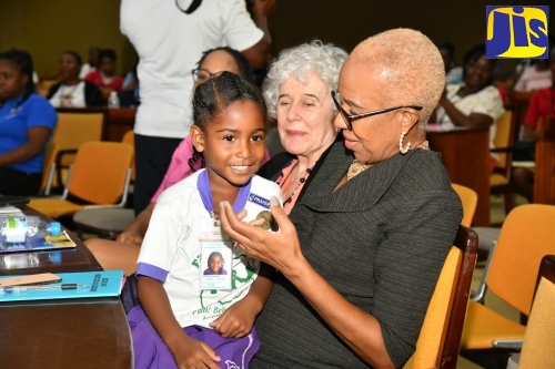 Minister of Education and Youth, Hon. Fayval Williams (right), engages with little Deborah Gangasingh from Faith Builders Early Childhood Institution, during the closing ceremony of the Early Childhood Commission’s (ECC) 5th Annual Professional Development Institute at the Jamaica Conference Centre, downtown Kingston on Friday (May 24). Looking on is World President of the World Organization for Early Childhood Education, Mercedes Mayol Lassalle. The five-day event was held under the theme: ‘A Place to Belong: A Child’s Right to Quality Early Childhood Education.