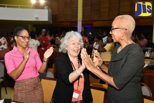 Minister of Education and Youth, Hon. Fayval Williams (right), exchanges a double high-five with World President of the World Organization for Early Childhood Education, Mercedes Mayol Lassalle (centre), during the closing ceremony of the Early Childhood Commission’s (ECC) 5th Annual Professional Development Institute at the Jamaica Conference Centre, downtown Kingston on Friday (May 24). Sharing the moment is Senior Lecturer for Early Childhood Education at the University of the West Indies (UWI), Dr. Zoyah Kinkead-Clark. The five-day event, held under the theme: ‘A Place to Belong: A Child’s Right to Quality Early Childhood Education,’ brought together local, regional and international stakeholders to exchange research ideas and experiences that shape early-childhood development today.