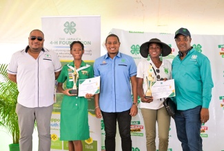 Minister of Agriculture, Fisheries and Mining, Hon. Floyd Green (centre), celebrates with Jamaica 4-H Clubs Girl of the Year, Deneila Wright (second left), at the 4-H National Achievement Expo, held at the Denbigh 4-H Centre, in Clarendon on May 10. Others (from left) are Chairman of the 4-H Clubs, Collin Virgo; Tricia Elliot, mother of Rhondre Elliot, who was crowned the 4-H Boy of the Year and Executive Director of the organisation, Peter Thompson.