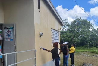 Contestants of this year’s Westmoreland Festival Queen Competition paint a section of the Cornwall Mountain Health Centre in Westmoreland during Labour Day activities at the facility on (Thursday) May 23.