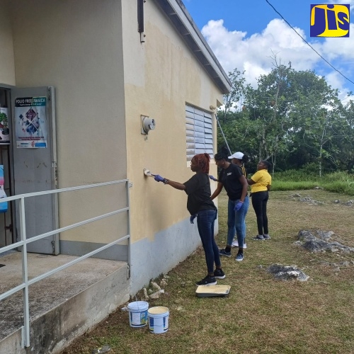 Contestants of this year’s Westmoreland Festival Queen Competition paint a section of the Cornwall Mountain Health Centre in Westmoreland during Labour Day activities at the facility on (Thursday) May 23.