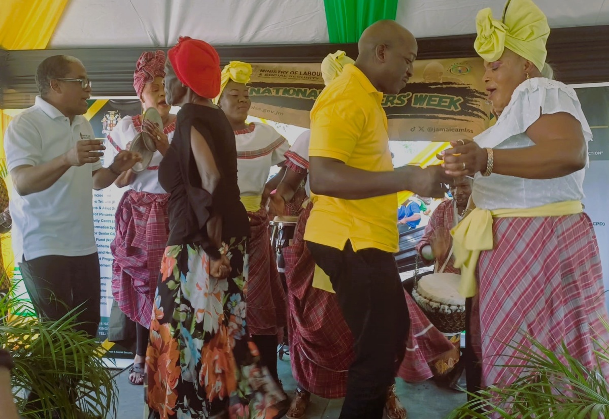 Minister of Labour and Social Security, Hon. Pearnel Charles Jr. ( second right) and Minister of State in the Ministry, Dr. the Hon. Norman Dunn (left), dance with a member of the Hanover Senior Citizens’ Group, and a member of the Hatfield Cultural Group, during the Frome Workers’ Park Reflection at Workers' Park in Westmoreland, on May 17.

