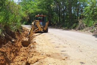 A section of the Burnt Ground main road in Hanover being excavated for the construction of a French drain.

