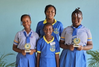 St. Thomas Hill-View Kinder Preparatory School strikes gold at the St. Thomas 4-H Clubs Parish Achievement Day with students Samoi Lattibeaudiere (left) winning the Fruit Slush Competition; Catalaya Gayle (centre), Recitation; and Rosheen Sylva (right) winning in the Making of Staplewich category. Sharing the moment with the students is President of the institution’s 4-H Club and Teacher, Melissa Brown (back row). The achievement day was held recently at the Seaforth High School campus in the parish.

