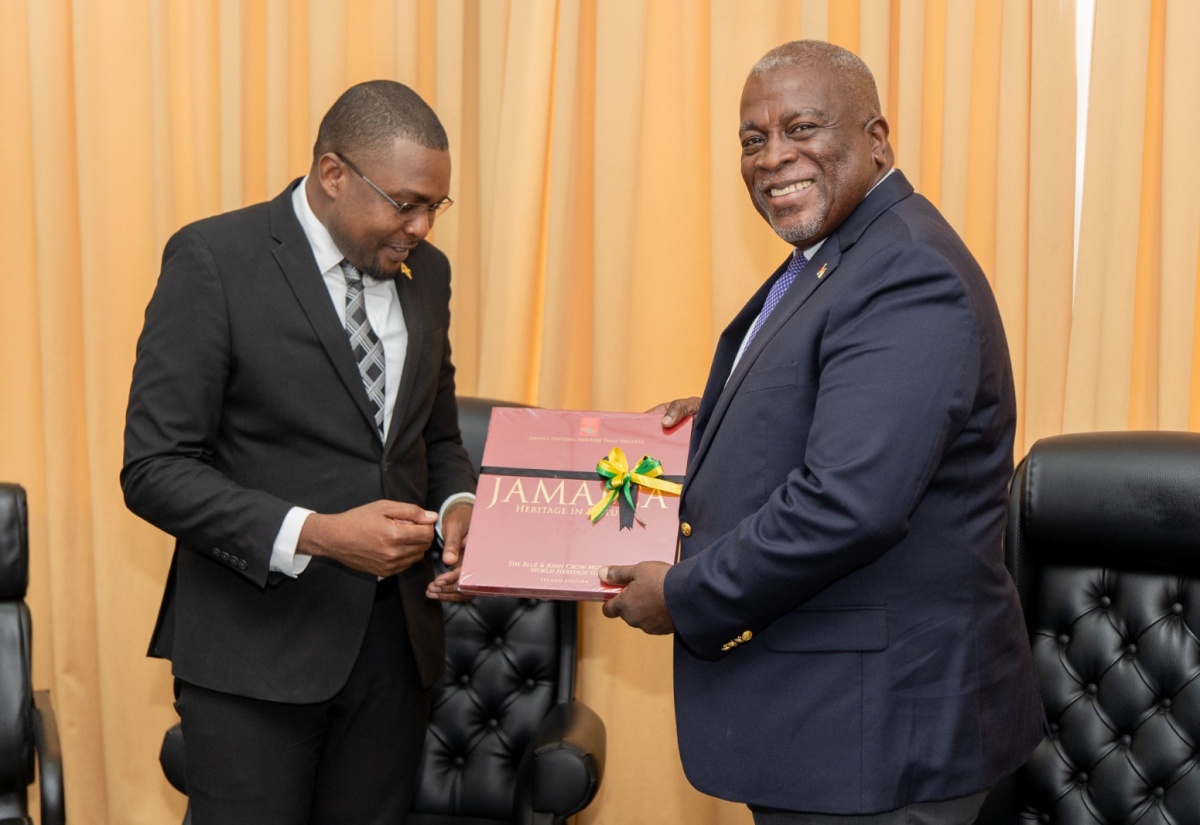 Minister without Portfolio in the Office of the Prime Minister with responsibility for Information, Hon. Robert Morgan (left), presents a book entitled ‘Jamaica: Heritage in Pictures’ to Prime Minister of Guyana, Hon. Brigadier (Ret
