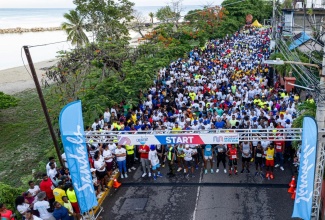 Thousands of persons assemble at the start line for the Jill Stewart MoBay City Run in the St. James capital on Sunday (May 5).
