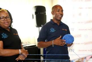 Department of Correctional Services (DCS) Officer, Audley Vernon, enjoys one of the unique Passport to Success (PTS) participatory exercises while qualifying as a PTS Master Trainer in 2023. Master Trainer and Kellits High School Guidance Counsellor, Faith Byfield (left), served as Master Coach for the four-day workshop, during which 12 Clarendon-based youth workers were trained for assessment and certification as PTS Trainers and Coaches.
