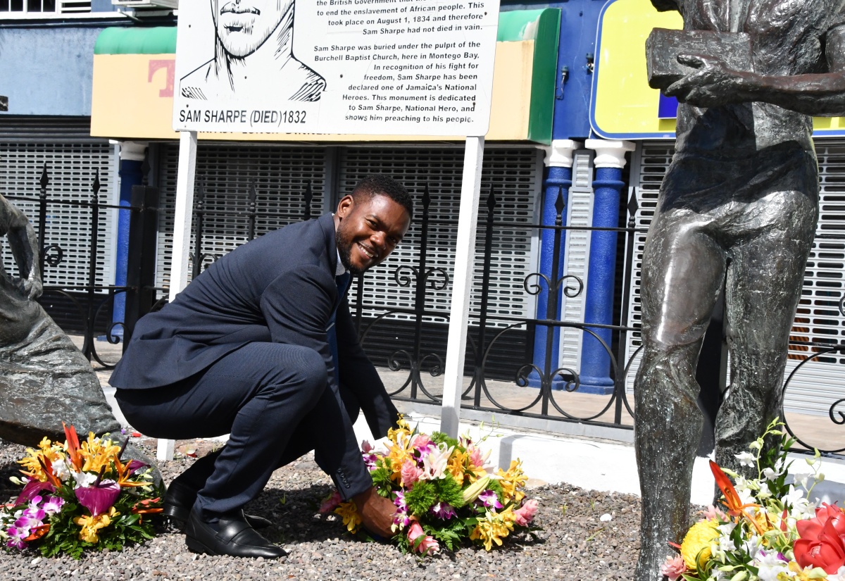 Mayor of Montego Bay, Councillor Richard Vernon, places flowers at the monument in Sam Sharpe Square, Montego Bay, St. James, in honour of National Hero, the Right Excellent Samuel Sharpe, on Labour Day, Thursday (May 23).