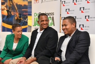 Minister of Agriculture, Fisheries and Mining, Hon. Floyd Green (right), is in discussion with President of the Mining and Quarrying Association of Jamaica, Samuel Millington (centre) and Director at Lydford Mining Company, Jackie Millington, at a recent minerals sector exhibition and trade show held at the Ministry’s Hope Gardens complex in St. Andrew. 