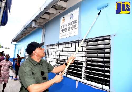 Prime Minister, the Most Hon. Andrew Holness, paints the exterior wall of the Olympic Gardens Health Centre in Kingston on Labour Day (May 23).