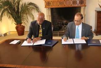 University of the West Indies (UWI) Vice Chancellor, Professor Sir Hilary Beckles and State University of New York at Buffalo (SUNY) President, Satish K. Tripathi, sign a memorandum of understanding (MOU) between the two universities to foster greater cooperation. The signing took place in Buffalo, New York, on Monday (May 20).