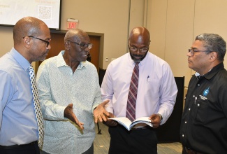 Minister of Local Government and Community Development, Hon. Desmond McKenzie (second left), is in discussion with stakeholders during the second Working Session of the National Disaster Risk Management Council held on Thursday (May 2), at AC Hotel by Marriott in Kingston. Also sharing in the discussion (from left) are Director of the Meteorological Service of Jamaica, Evan Thompson; Office of Disaster Preparedness and Emergency Management (ODPEM) Director General, Richard Thompson; and Managing Director of the Water Resources Authority, Peter Clarke.

