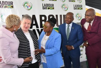 Minister of Culture, Gender, Entertainment and Sport, Hon. Olivia Grange (centre), engages with Professor Emerita, University of the West Indies (UWI) Mona Ageing and Wellness Centre, Dr. Denise Eldemire-Shearer (second left); and HEART/NSTA Trust Managing Director, Dr. Taneisha Ingleton (left), during Friday’s (May 10) Workers’ Week and Labour Day launch, at the Ministry’s offices in New Kingston. Looking on are Minister of Labour and Social Security, Hon. Pearnel Charles Jr. (second right), and Director of the UWI’s Centre for Disability Studies, Senator, Dr. Floyd Morris. 