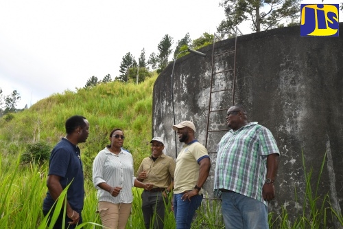 Member of Parliament for East Rural St. Andrew, the Most Hon. Juliet Holness, is in discussion with (from left) Water Supply Manager, National Water Commission (NWC), Chadron Stern; Managing Director, Water Resources Authority (WRA), Peter Clarke; Vice President, NWC, Herman Fagan; and Councillor, Mavis Bank Division, Lloyd Benjamin. Occasion was a tour of water projects in the constituency on Friday (May 24).