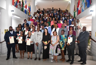 Custos Rotulorum for St. Andrew, Hon. Ian Forbes (fourth left, front row), shares a photo opportunity with the 112 newly commissioned Justices of the Peace for the parish. They were sworn into office during a ceremony at the Caribbean Military Academy Auditorium, Jamaica Defence Force (JDF) Headquarters, Up Park Camp, Kingston, on Saturday (May 18).