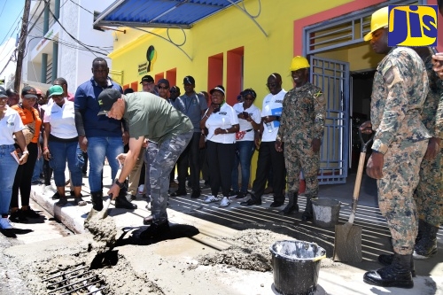 Prime Minister, the Most Hon. Andrew Holness (centre), mixes concrete during work on the 2024 National Labour Day Project, held at the Institute of Jamaica (IOJ), downtown Kingston, on Thursday (May 23). Activities focused on the building of a ramp to enhance access to the Institute’s cultural and heritage resources.