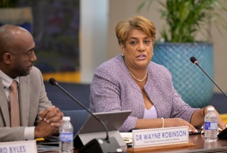 Bank of Jamaica (BOJ) Deputy Governor, Natalie Haynes, addresses Tuesday's (May 21) BOJ Quarterly Monetary Policy Press Conference. Listening is BOJ Senior Deputy Governor, Dr. Wayne Robinson.

