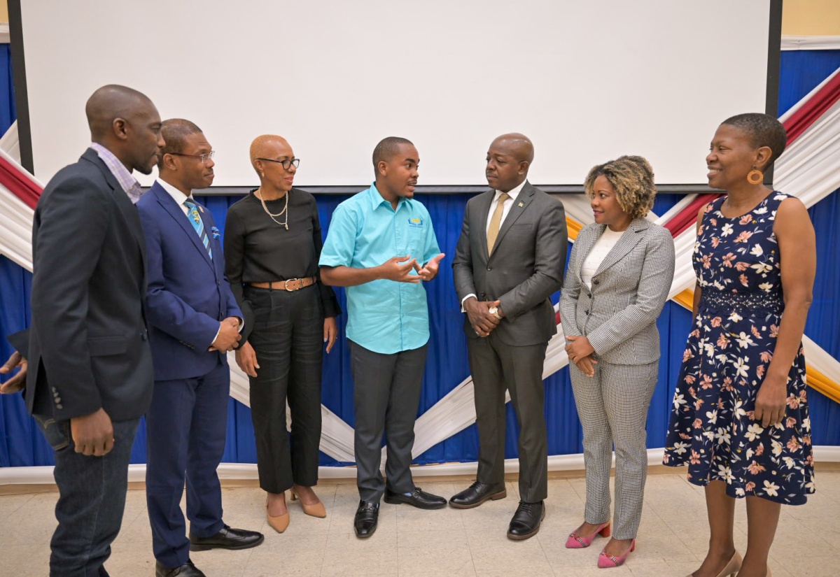 Minister without Portfolio in the Office of the Prime Minister with responsibility for Skills and Digital Transformation, Senator Dr. the Hon. Dana Morris Dixon (second right), listens to Founder and Executive Director of Youth Education Association, Tahje Wallen (centre), at the Youth Education Association’s Youth in Accounting and Auditing Conference, held at the University of Technology, Jamaica (UTech) in St. Andrew, on Tuesday (May 14). Also listening (from left) are  President of the Institute of Chartered Accountants, Eric Scott; UTech President, Dr. Kevin Brown; Minister of Education and Youth, Hon. Fayval Williams;  Minister of Labour and Social Security, Hon. Pearnel Charles Jr. and Head School of Business Administration, UTech, Celia McKoy.

