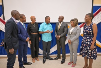 Minister without Portfolio in the Office of the Prime Minister with responsibility for Skills and Digital Transformation, Senator Dr. the Hon. Dana Morris Dixon (second right), listens to Founder and Executive Director of Youth Education Association, Tahje Wallen (centre), at the Youth Education Association’s Youth in Accounting and Auditing Conference, held at the University of Technology, Jamaica (UTech) in St. Andrew, on Tuesday (May 14). Also listening (from left) are  President of the Institute of Chartered Accountants, Eric Scott; UTech President, Dr. Kevin Brown; Minister of Education and Youth, Hon. Fayval Williams;  Minister of Labour and Social Security, Hon. Pearnel Charles Jr. and Head School of Business Administration, UTech, Celia McKoy.

