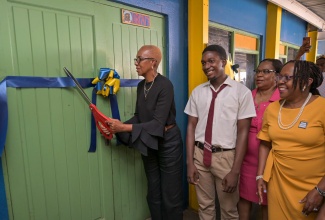 Minister of Education and Youth, Hon. Fayval Williams (left), formally opens a room at the Randolph Lopez School of Hope in St. Andrew, which was outfitted with computers donated by the Kiwanis Club of New Kingston. The room was officially opened during a brief handover ceremony on Tuesday (May 14). Sharing the moment are (from second left) student at the school and President of the Aktion Club, Anthony Lopez; Major Projects Chair, Kiwanis Club of New Kingston, Pat Garel, and the Club’s Distinguished President for 2022-23, Professor Aldrie Henry-Lee.

