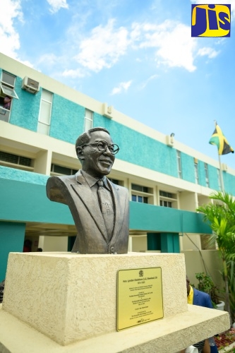Prime Minister, the Most Hon. Andrew Holness (right), and Minister of Culture, Gender, Entertainment and Sport, Hon. Olivia Grange, hold a replica of the Lynden G. Newland bust. Occasion was the unveiling for the sculpture in honour of the late former Labour Minister, at the Ministry of Labour and Social Security’s National Heroes Circle location in Kingston on May 22. Sharing the moment is Labour and Social Security Minister, Hon. Pearnel Charles Jr.