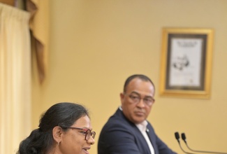 Minister of Health and Wellness, Dr. the Hon. Christopher Tufton, listens as Chief Medical Officer, Dr. Jacquiline Bisasor-McKenzie, addresses Wednesday’s (May 15) post-Cabinet press briefing at Jamaica House. 