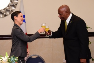 Minister of Foreign Affairs and Foreign Trade, Senator the Hon. Kamina Johnson Smith (left) and Ambassador of the Republic of Panama to Jamaica and Dean of the Diplomatic Corps, His Excellency Lasford Douglas, raise a toast during a farewell diplomatic lunch held on June 21 at the Jamaica Pegasus Hotel in New Kingston.