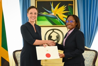 Minister of Foreign Affairs and Foreign Trade, Senator the Hon. Kamina Johnson Smith (left), presents Jamaica’s Ambassador-designate to Mexico, Julia Hyatt, with her Letter of Credence during their meeting at the Office of the Prime Minister (OPM) on Monday (June 24).