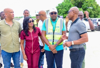 Minister without Portfolio in the Ministry of Economic Growth and Job Creation with Responsibility for Works, Hon. Robert Morgan (second right), gets an update on work along a section of the Southern Coastal Highway Improvement Project (SCHIP), between Harbour View in St. Andrew and Golden Grove in St. Thomas, from National Works Agency (NWA) Chief Executive Officer, Everton G. Hunter (right), during a tour of the segment on Friday (June 7). Also listening are (from left) the Members of Parliament for St. Thomas Western, James Robertson, and St. Thomas Eastern, Dr. Michelle Charles.