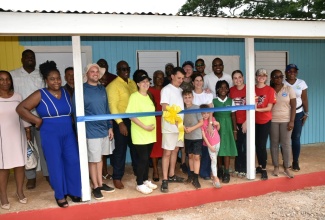 Minister without Portfolio in the Ministry of Economic Growth and Job Creation with Responsibility for Works, Hon. Robert Morgan (right, second row), joins representatives of Food For the Poor, Kind Heart Foundation, teachers, staff students of Brixton Hill Primary and Infant School in Clarendon, at the official handover of the institution’s newly constructed Infant Department building on Sunday (June 9). Mr. Morgan is Member of Parliament for Clarendon North Central, where the school is located. The building’s construction was spearheaded by Food For the Poor.