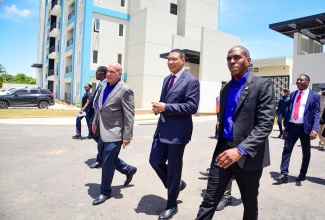 Prime Minister, the Most Hon. Andrew Holness (centre), along with President and Chief Executive Officer of Sagicor Group, Christopher Zacca (left), and Assistant Vice President at the Sagicor Group, Shane Walters (right), tour the New Brunswick Village in Spanish Town, St. Catherine. The mixed housing and commercial development, representing a $6-billion investment by Sagicor, was officially opened on Wednesday (June 19).
