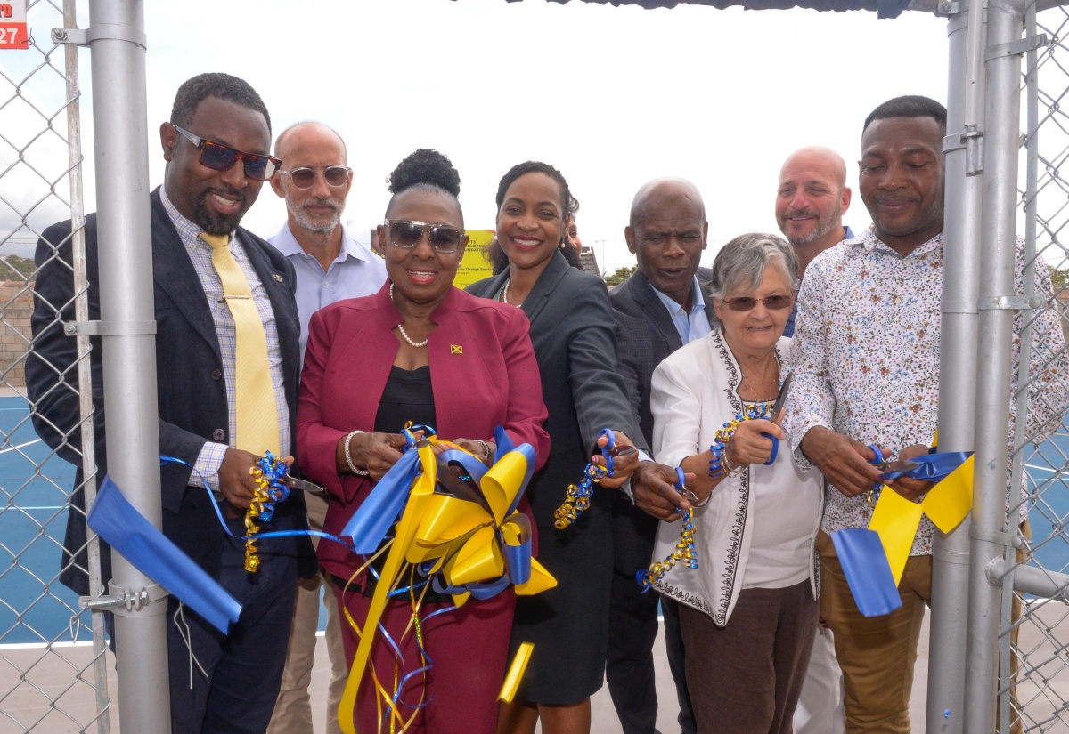 Minister of Culture, Gender, Entertainment and Sport, Hon. Olivia Grange (third left), and Minister of State in the Ministry of Education and Youth, Hon. Marsha Smith (fourth left), lead in the ribbon-cutting at the multipurpose court at the tuition-free Christel House, at Twickenham Park, St. Catherine, today (June 4). Others pictured (from left) are Executive Principal of the school, Jason Scott; General Manager of the Sport Development Foundation of Jamaica, Alan Beckford;  Custos of Kingston and Chairman of the school, Hon. Steadman Fuller; National Ambassador for Christel House Jamaica, Sally Porteous; and Councillor for the Westchester Division, Renair Benjamin, who represented Mayor of Spanish Town, Councillor Norman Scott.

