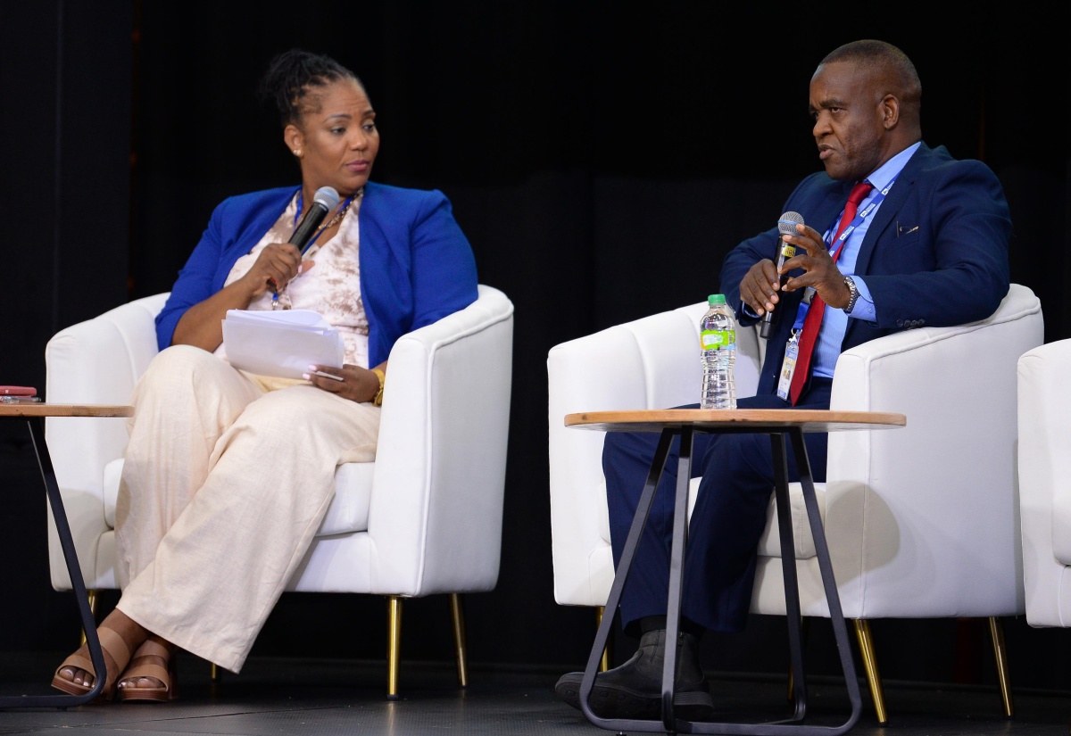 Commissioner of Police, Dr. Kevin Blake (right), speaks at the 10th Biennial Jamaica Diaspora Conference at the Montego Bay Convention Centre in St. James, on June 17. Also pictured is media personality, Dahlia Harris.