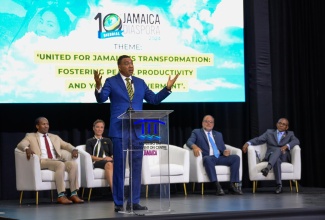 Prime Minister, the Most Hon. Andrew Holness (at lectern), emphasises a point during the opening ceremony for the 10th Biennial Jamaica Diaspora Conference at the Montego Bay Convention Centre in St. James on Tuesday (June 18). Listening are (from left) Minister of State in the Ministry of Foreign Affairs and Foreign Trade, Hon. Alando Terrelonge; Minister of Foreign Affairs and Foreign Trade, Senator the Hon. Kamina Johnson Smith; Leader of the Opposition, Mark Golding; and President and Chief Executive Officer, VM Group and Diaspora Conference Chair,  Courtney Campbell.

