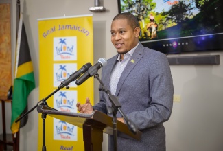Minister of Agriculture, Fisheries and Mining, Hon. Floyd Green, delivers remarks during Friday’s (June 28) launch of local entity, Tripple C Manufacturing’s ‘Island Taste’ brand of canned soup and meat at the Jamaica Promotions Corporation (JAMPRO) Auditorium in New Kingston.