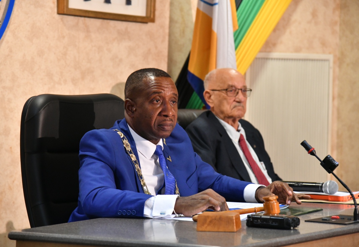 Mayor of Kingston, Councillor Andrew Swaby (left), addresses the Kingston and St. Andrew Municipal Corporation (KSAMC) recent monthly sitting. The meeting was held at the Corporation’s Chambers in downtown Kingston. Beside Councillor Swaby is former Jamaica Olympic Association (JOA) President, Mike Fennell, who was a guest at the sitting.

