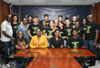 Minister of State in the Ministry of Education and Youth, Hon. Marsha Smith (seated second right) and Acting Chief Education Officer, Ministry of Education and Youth, Terry-Ann Thomas-Gayle (seated second left) share a photo opportunity with members of a delegation from Boston College in Montserrat during their visit to the Ministry’s Heroes Circle offices in Kington on June 3.